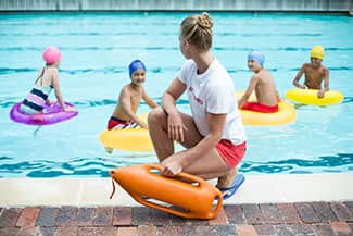 Be vigilant when a child is in or near the bathtub, toilet, pools, spas or buckets. Lifeguard watching kids in a pool
