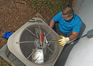 Air conditioning technician maintenancing a unit