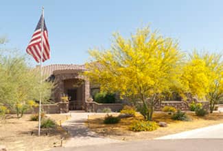 Desert landscaping with lush, yellow palo verde trees offer great shade.