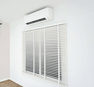 Ductless A/C mini split: indoor unit above a window