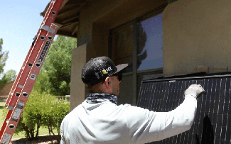 Solar technician with a solar panel 